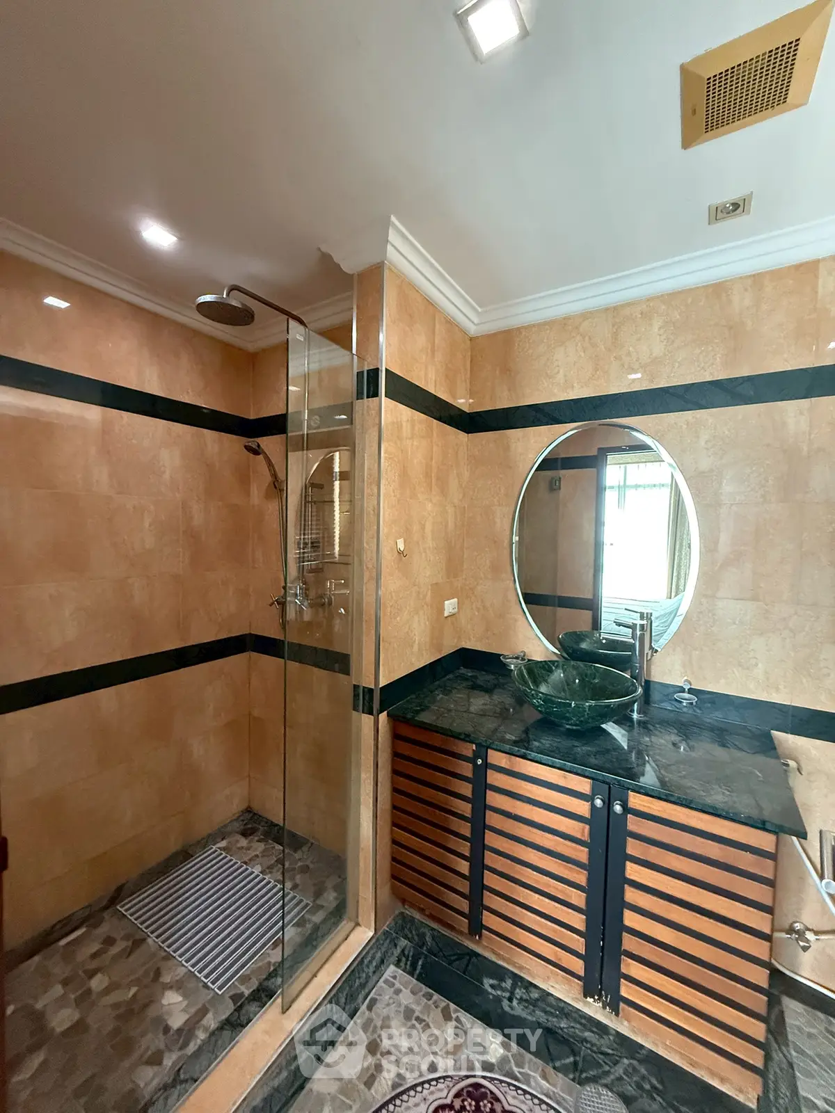Luxurious bathroom with elegant marble finishes and modern glass shower enclosure.