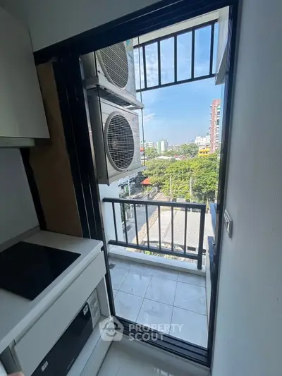 Modern apartment balcony with city view and air conditioning units, perfect for urban living.