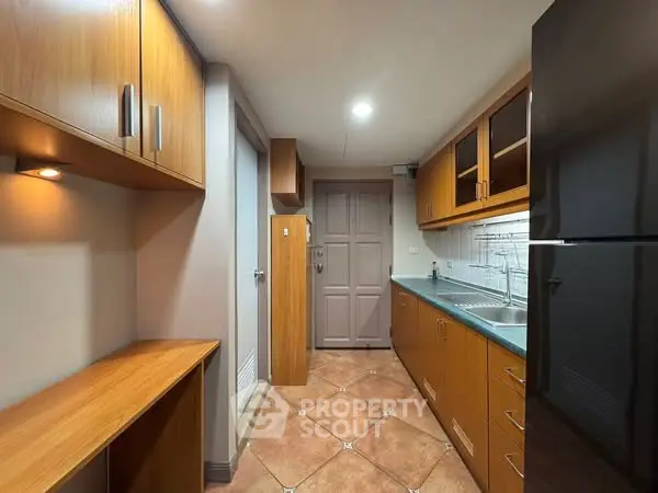 Spacious kitchen with wooden cabinets and modern appliances