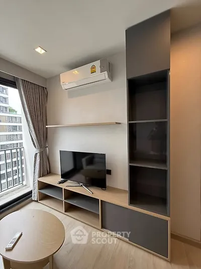 Modern living room with air conditioning and sleek TV setup in a stylish apartment.