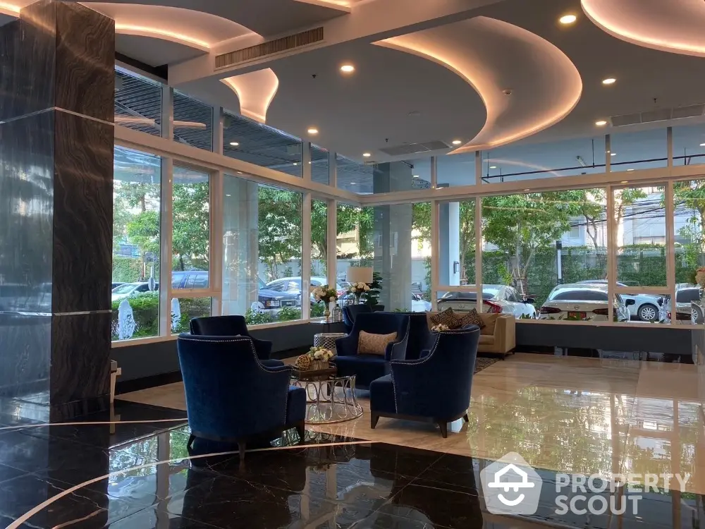 Luxurious modern lobby with elegant seating and large windows offering garden views