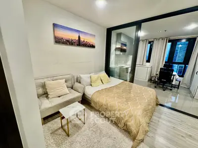 Modern studio apartment with cozy bed and city view, ideal for urban living.