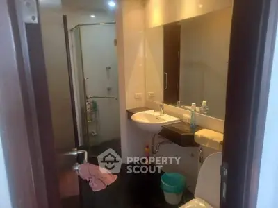 Modern bathroom with glass shower and sleek fixtures in a contemporary home.