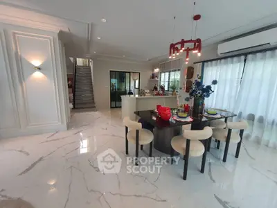 Luxurious open-plan living area with modern dining set and elegant decor