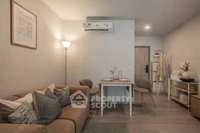 Cozy living room with modern decor and dining area, perfect for urban living.