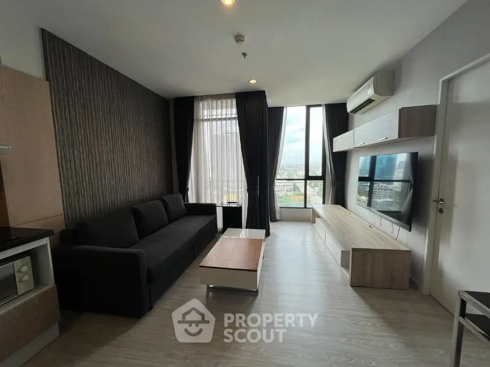 Modern living room with sleek furniture and city view, ideal for urban living.