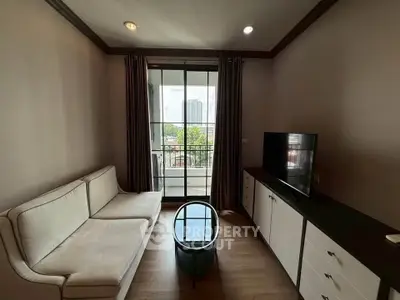 Cozy living room with modern furniture and balcony view in urban apartment