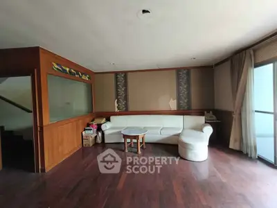 Spacious living room with elegant wooden flooring and cozy corner sofa