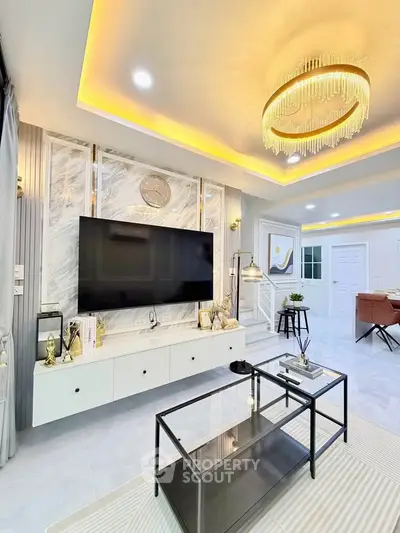 Luxurious modern living room with elegant chandelier and marble TV wall