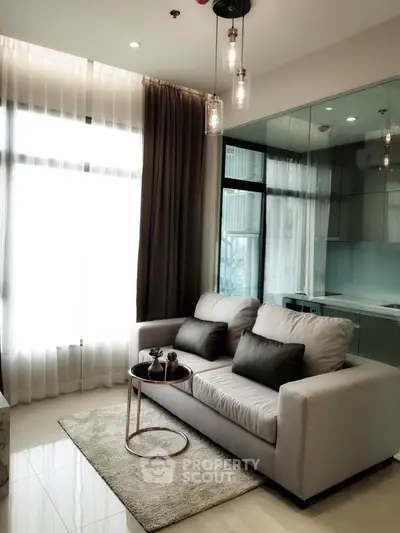 Modern living room with elegant sofa and floor-to-ceiling windows in a stylish apartment.