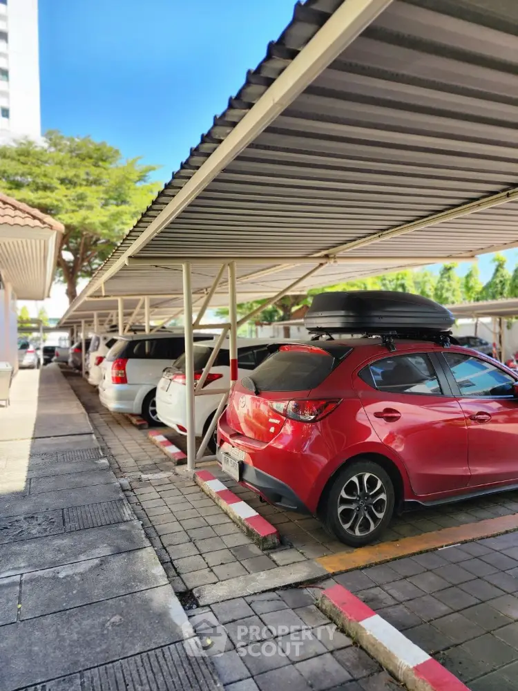 Covered parking area with multiple cars in a residential complex