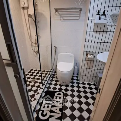 Compact modern bathroom with checkered floor and glass shower enclosure.