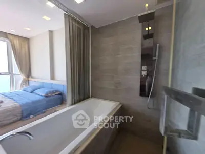 Modern bathroom with bathtub and adjacent bedroom in luxury apartment