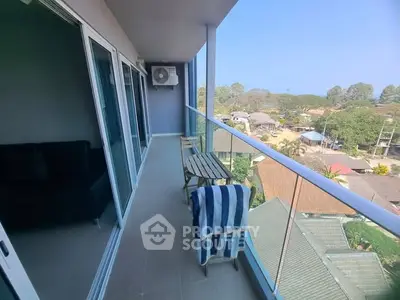 Spacious balcony with stunning view, perfect for relaxation and outdoor dining.