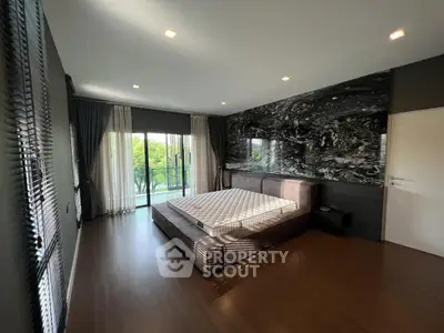 Spacious bedroom with modern design and balcony access