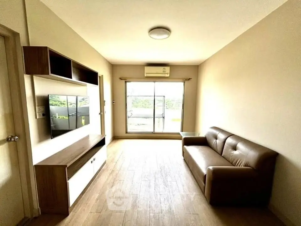 Modern living room with sleek furniture and natural light, perfect for relaxation and entertainment.