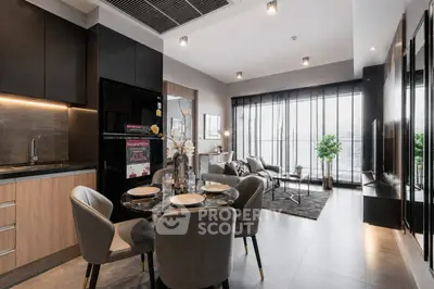 Modern open-layout living room with stylish kitchen and dining area, featuring elegant decor and ample natural light.