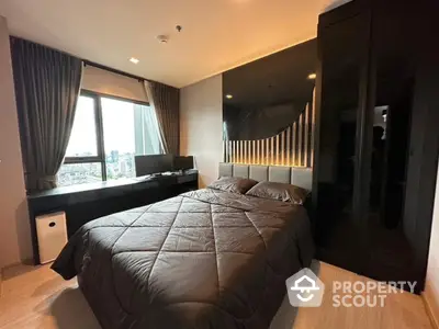 Modern bedroom with city view, sleek black wardrobe, and cozy bedding in a stylish apartment.