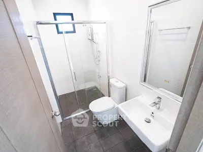 Modern bathroom with sleek fixtures and glass shower enclosure