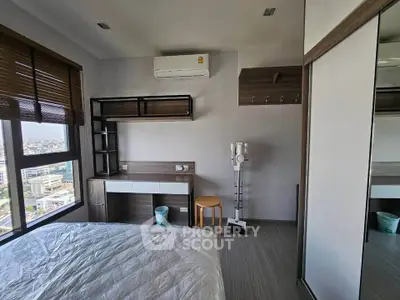 Modern bedroom with city view, featuring sleek furniture and air conditioning, perfect for urban living.