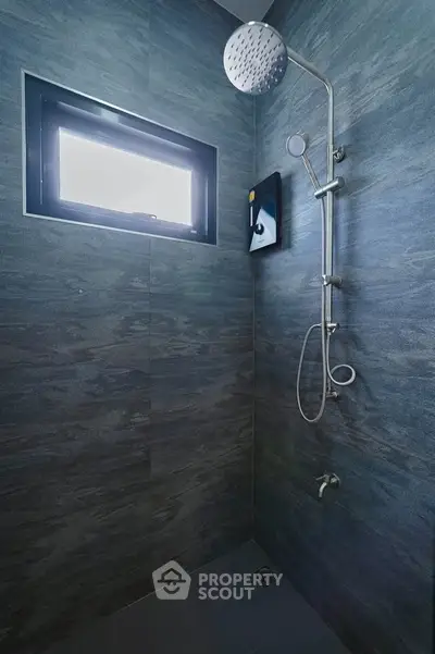 Modern bathroom with sleek shower and window for natural light