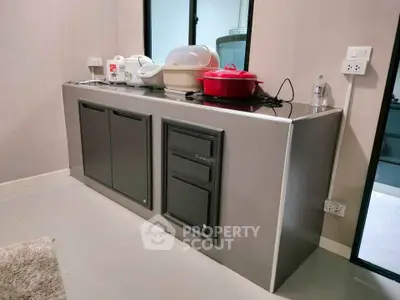 Modern kitchen with sleek cabinets and appliances, perfect for culinary enthusiasts.