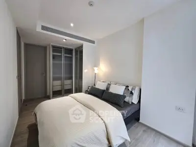Modern bedroom with stylish decor and ample natural light