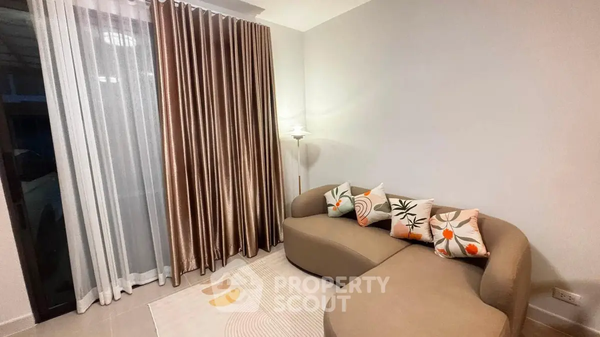 Stylish living room with modern curved sofa and elegant curtains