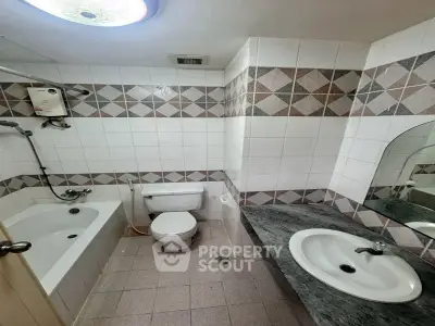 Cozy bathroom with bathtub and modern fixtures in a stylish apartment.