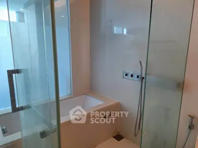 Modern bathroom with glass shower and built-in bathtub