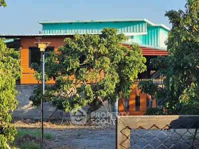 Charming rustic home with lush greenery and modern architectural elements.
