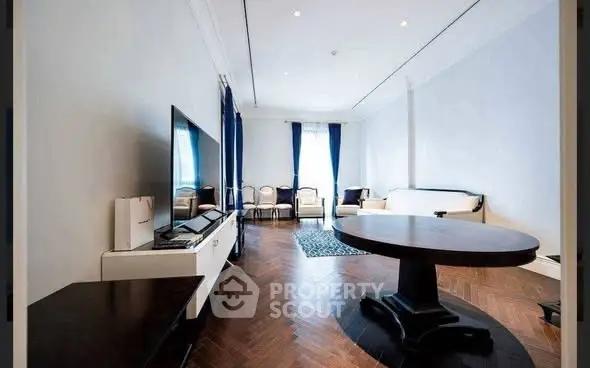Spacious living room with elegant hardwood flooring and modern furnishings.