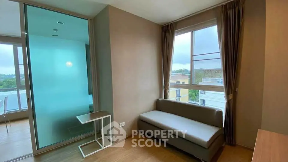 Modern living room with large windows and minimalist furniture, offering a bright and airy atmosphere.