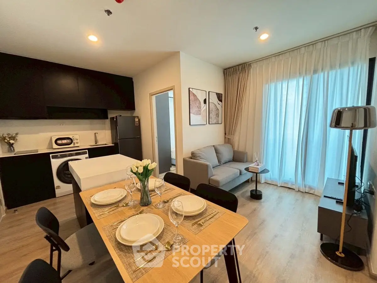 Modern open-layout kitchen and living room with stylish decor and natural light