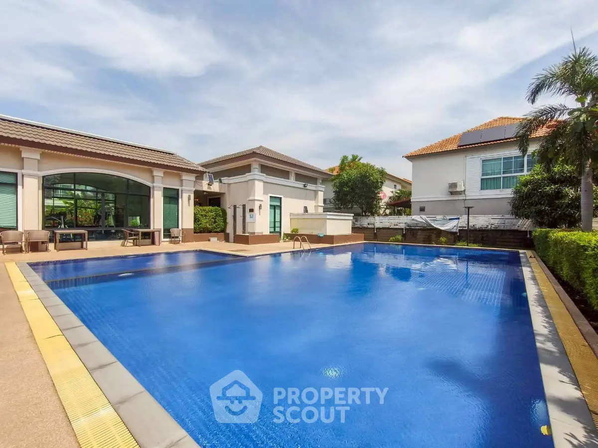 Luxurious residential complex with a stunning outdoor pool and modern architecture.