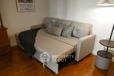 Cozy living room with a stylish pull-out sofa bed and modern decor.