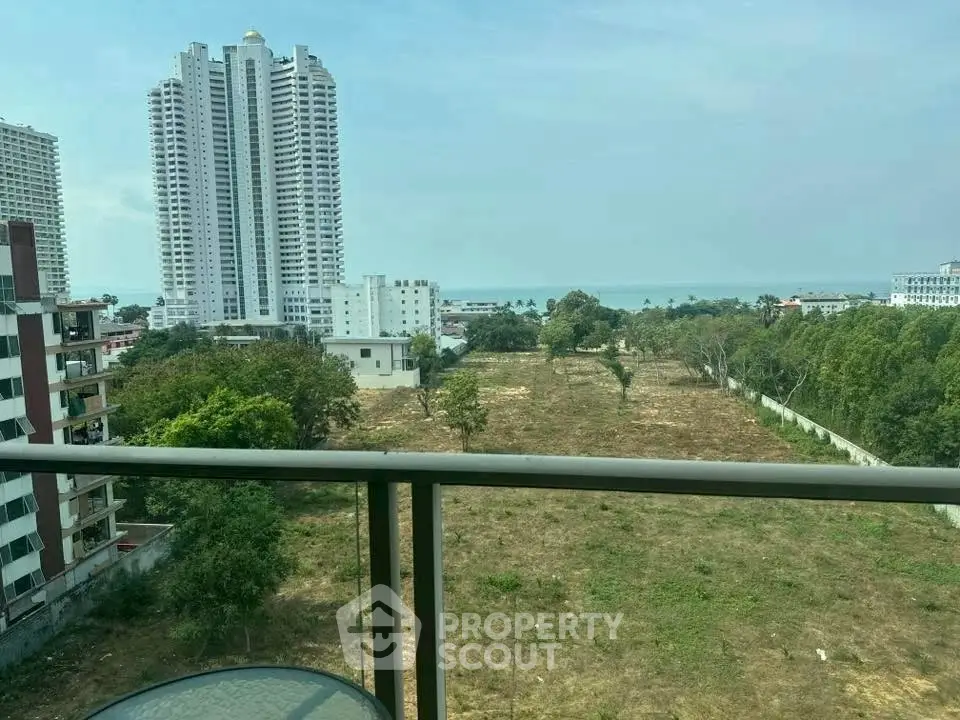 Stunning balcony view of cityscape and ocean horizon, perfect for urban living.