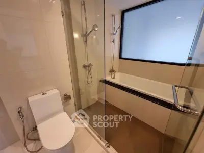 Modern bathroom with glass shower and bathtub in sleek design