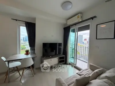 Modern living room with balcony and city view, featuring sleek furniture and natural light.