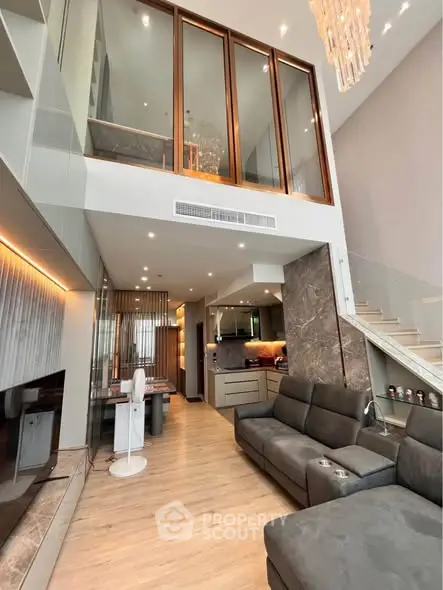 Luxurious modern living room with high ceiling and elegant staircase