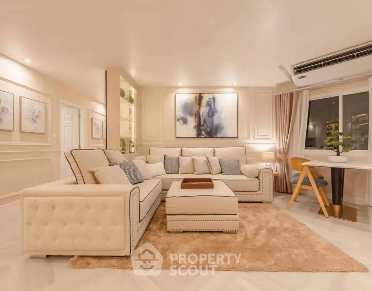 Luxurious living room with elegant decor and plush seating in modern apartment.