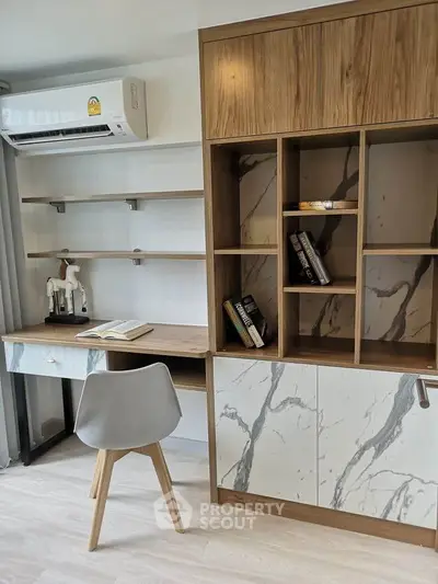 Modern study room with stylish shelving and desk, featuring elegant marble accents and contemporary design.