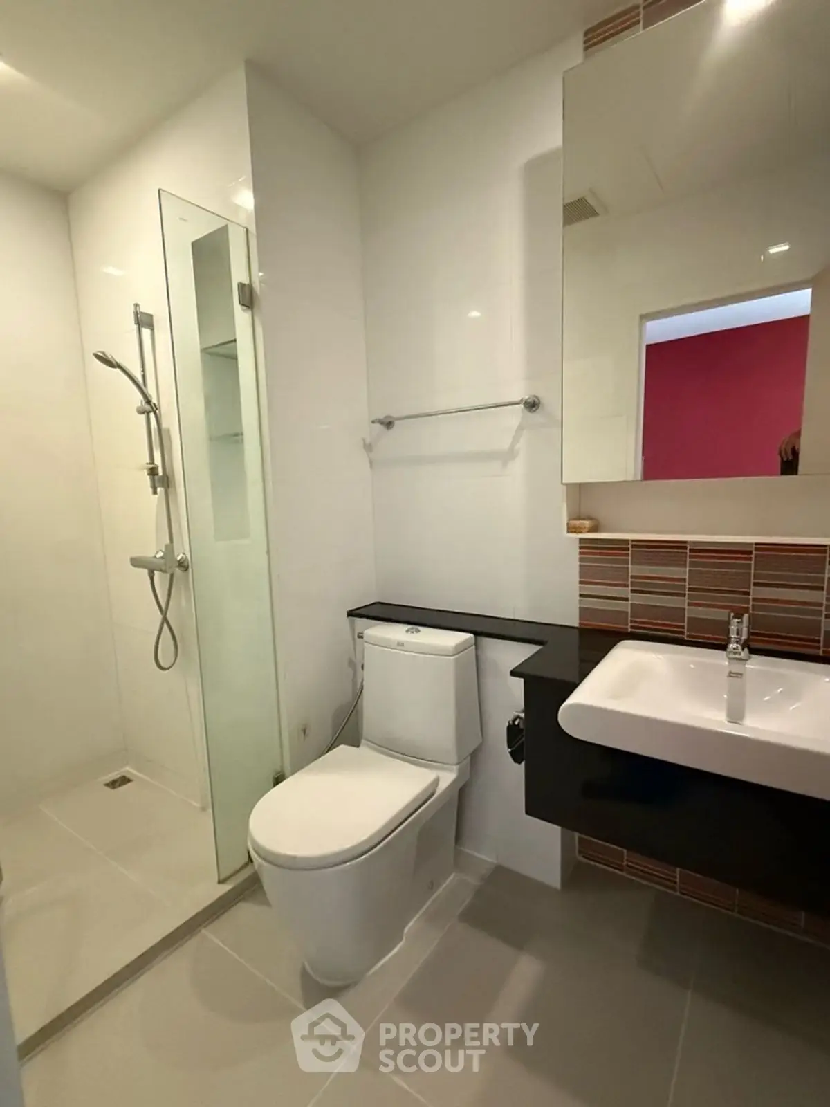 Modern bathroom with sleek shower and contemporary fixtures in stylish apartment.
