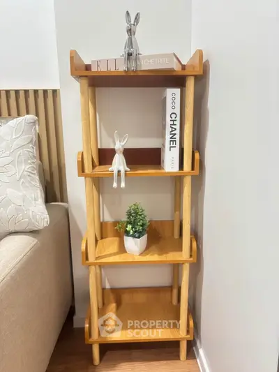 Stylish wooden shelf with decorative items in modern living room corner.