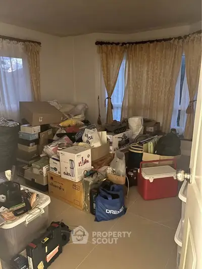 Cluttered storage room filled with boxes and miscellaneous items, ideal for organizing enthusiasts.