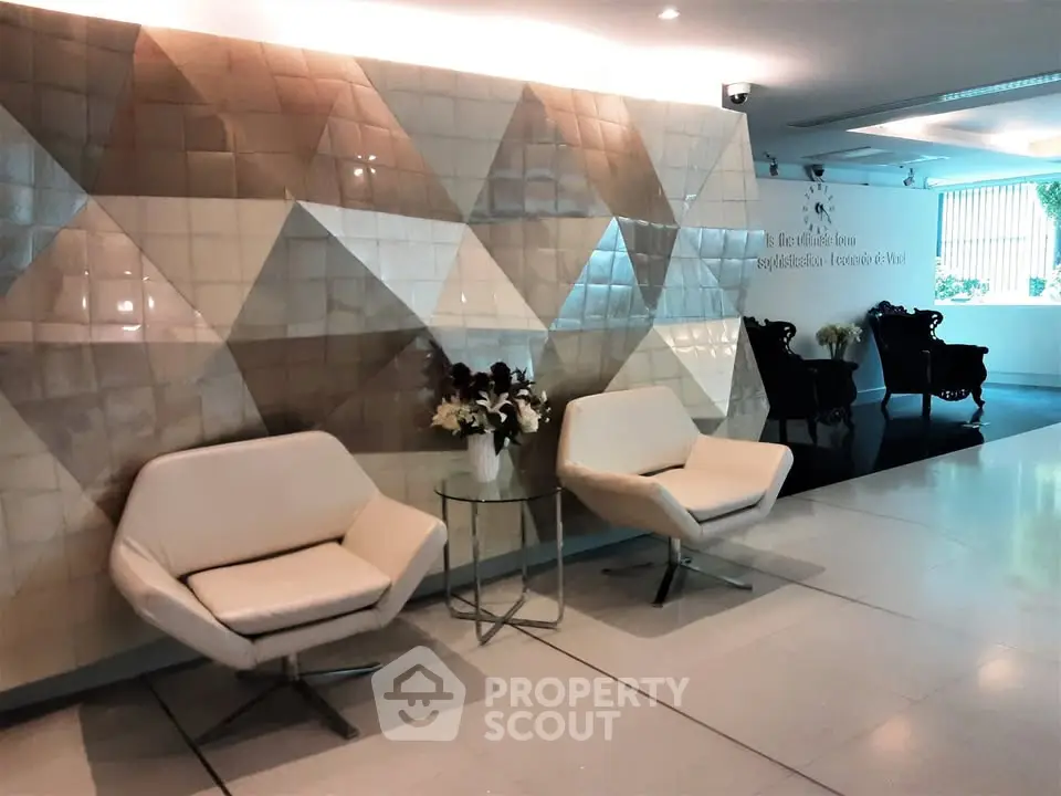 Stylish modern lobby with geometric wall tiles and elegant seating area