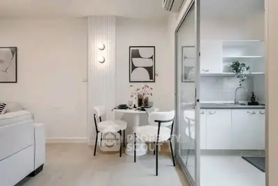 Modern open-plan living and dining area with sleek kitchen design.