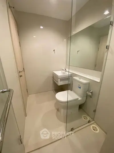 Modern minimalist bathroom with glass shower and sleek fixtures