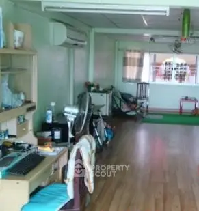 Spacious living area with wooden flooring and air conditioning