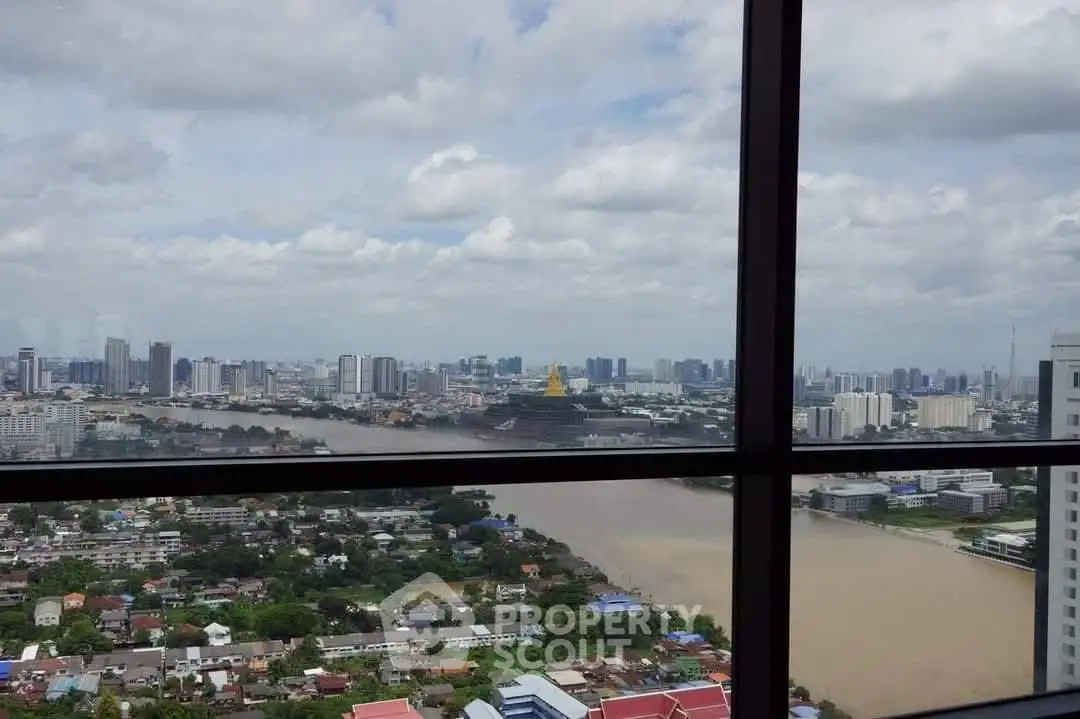 Stunning cityscape view from high-rise building window overlooking river and skyline.